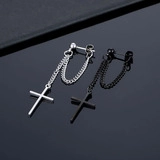 Detail of punk style stainless steel cross chain earrings in silver and black metal
