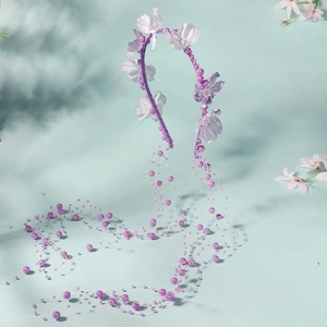 Detailed view of purple floral headband with dangling faux pearls and fringe tassels