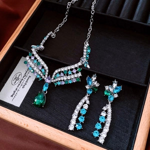Macro detail of vintage floral jewelry set with multi-colored crystals in a wood box