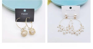 Detailed view of gold hoop earrings with pearls on 925 silver needle display cards