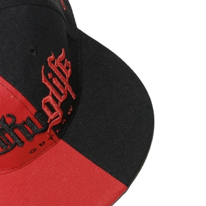 Close-up of high-density 3D 'Thug Life' embroidery on a red and black hip-hop cap