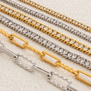 Macro shot of 18K gold and silver stainless steel bracelets with cubic zirconia accents