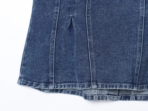 Detailed macro view of washed blue denim fabric with reinforced double stitching hem