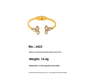 Detail view of gold plated stainless steel spring cuff with cubic zirconia clovers