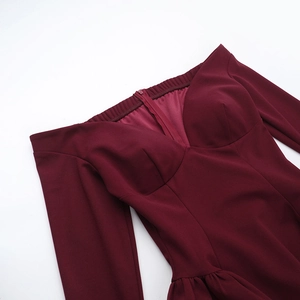 Detail of elegant burgundy dress showing off-shoulder V-neckline and zipper back