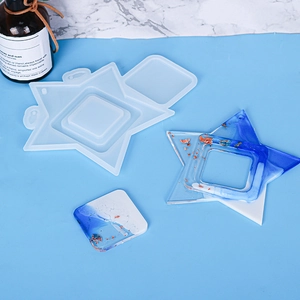 Macro view of star and square silicone resin molds with blue and gold foil finished pieces