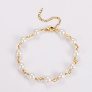 Detailed view of handmade baroque pearl bracelet with gold wire wrapping and lobster clasp