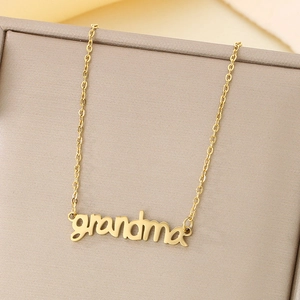 Macro detail of a golden necklace with grandma pendant inside a premium jewelry gift box