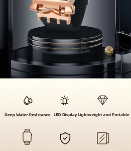 Close-up of golden LED digital watch with black silicone strap on display stand