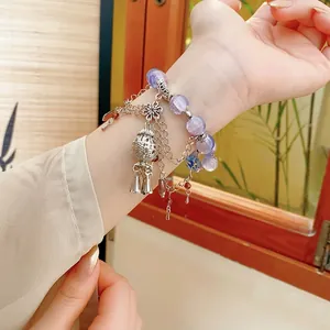 Flower bell wind chime beaded bracelet with purple glass beads and silver tassel charms