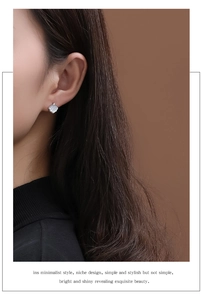 Close-up of S925 sterling silver ginkgo leaf stud earrings with white mother of pearl