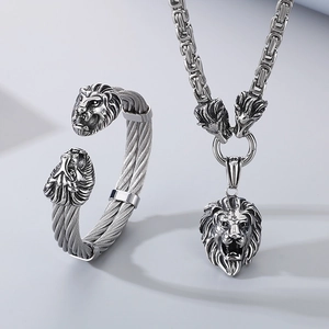 Detailed silver lion head jewelry set featuring braided steel bracelet and Byzantine chain