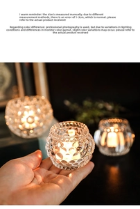 Detail view of pumpkin-shaped glass candle holders with textured patterns and warm tealight