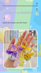 Close-up of unicorn liquid glitter keychains in purple and yellow with silicone straps