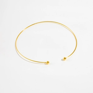 Detailed view of adjustable golden S925 sterling silver torque necklace with ball ends