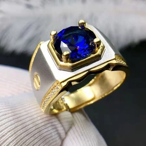 Luxurious two-tone men's ring featuring a deep blue gemstone and screw pattern design