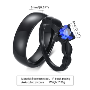 Detail view of black stainless steel couple rings with blue heart cubic zirconia stones