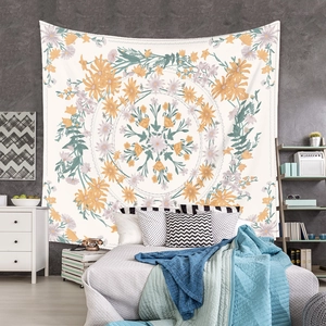 Detail of floral mandala tapestry hanging as background decoration on a grey wall