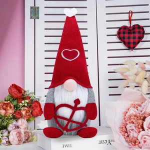 Valentine's Day faceless gnome plush with cupid arrow sitting on a book with roses