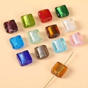 Macro view of colorful square glass beads for DIY jewelry making with pre-drilled holes