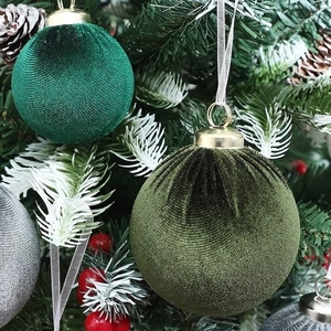 Velvet Christmas ball ornaments in green and grey with gold caps on a festive tree