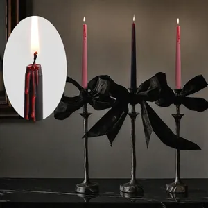 Gothic Halloween bleeding candles with black velvet bow holders for spooky party decor