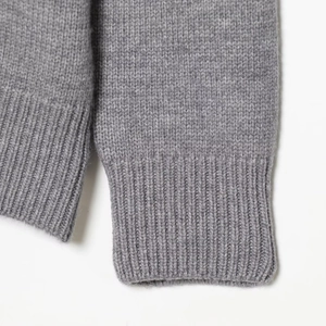Grey heavy-duty wool knit sweater featuring detailed ribbed cuffs and premium texture