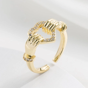 Gold open ring featuring a hands-holding-heart design with sparkling zircon stones