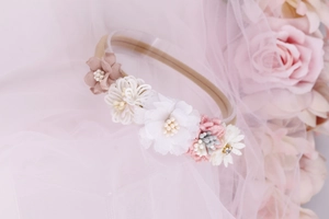 Close-up of handmade floral baby headband with mesh flowers and crochet details