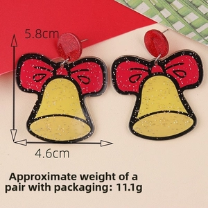 Detail view of yellow acrylic bell earrings with red bows, 5.8cm height for Christmas