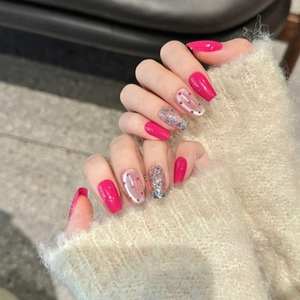 Magenta cat eye press-on nails with glitter accents and retro polka dot patterns
