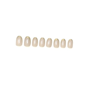Short oval press-on nails in light pink pearl finish with champagne gold French tips