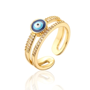 Macro view of double-layered 18K gold ring with evil eye and pavé set cubic zirconia