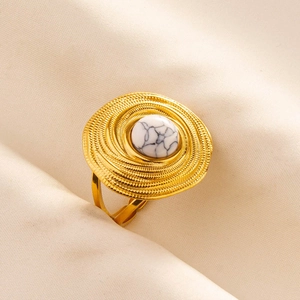 Detailed close-up of a vintage bohemian gold ring featuring a white stone inlay