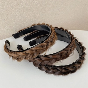 Three brown fishtail braided headbands for women on a minimal white surface