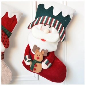 Detail view of red plush Christmas stocking featuring a 3D Santa and reindeer motif