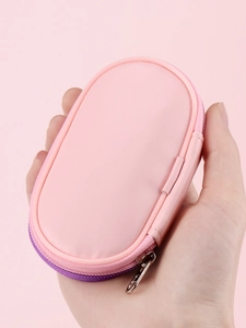 Close-up of pink faux leather oval makeup brush pouch with purple zipper and carry loop
