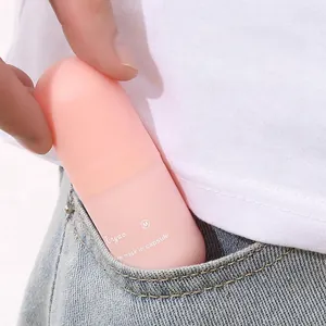 Portable pink capsule eye mask case being tucked into a pocket for travel use