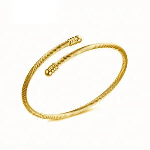 Golden stainless steel wire cable cuff bracelet with round ball ends in minimalist style