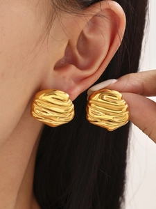 Detailed close-up of 18k gold-plated irregular hammered texture earrings on a model