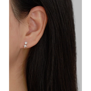 Detail view of s925 silver four-pointed star stud earring with crystals on a female model