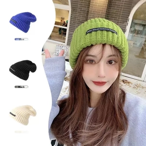 Detailed knit texture of thick winter beanie with woven label and multiple color options