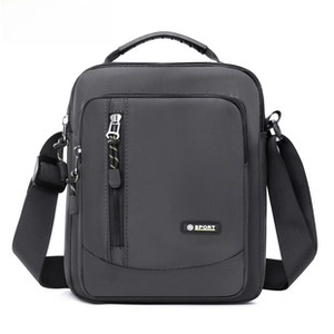 Detail of water-resistant oxford fabric and functional zippers on the gray shoulder bag