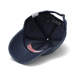 Detail showing USA embroidery and cotton wash label inside dark blue baseball cap