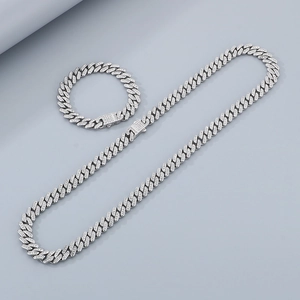 Close-up of diamond-encrusted Cuban link necklace and bracelet set in polished silver finish