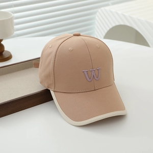 Close-up of khaki cotton baseball cap featuring purple 3D embroidered W and cream piping