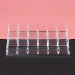Clear acrylic lipstick organizer with 18 individual slots for desktop cosmetic storage