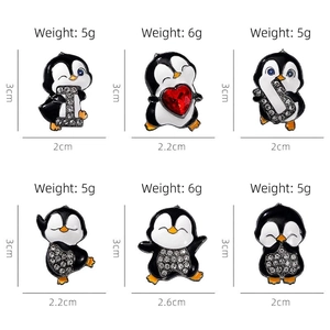 Set of cute enamel penguin brooches with rhinestones and heart details in various poses