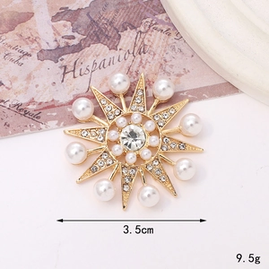 Detailed close-up of golden sunflower brooch with crystals and pearls on white background