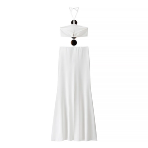 Detail of white two-piece set featuring halter crop top with ring hardware and maxi skirt